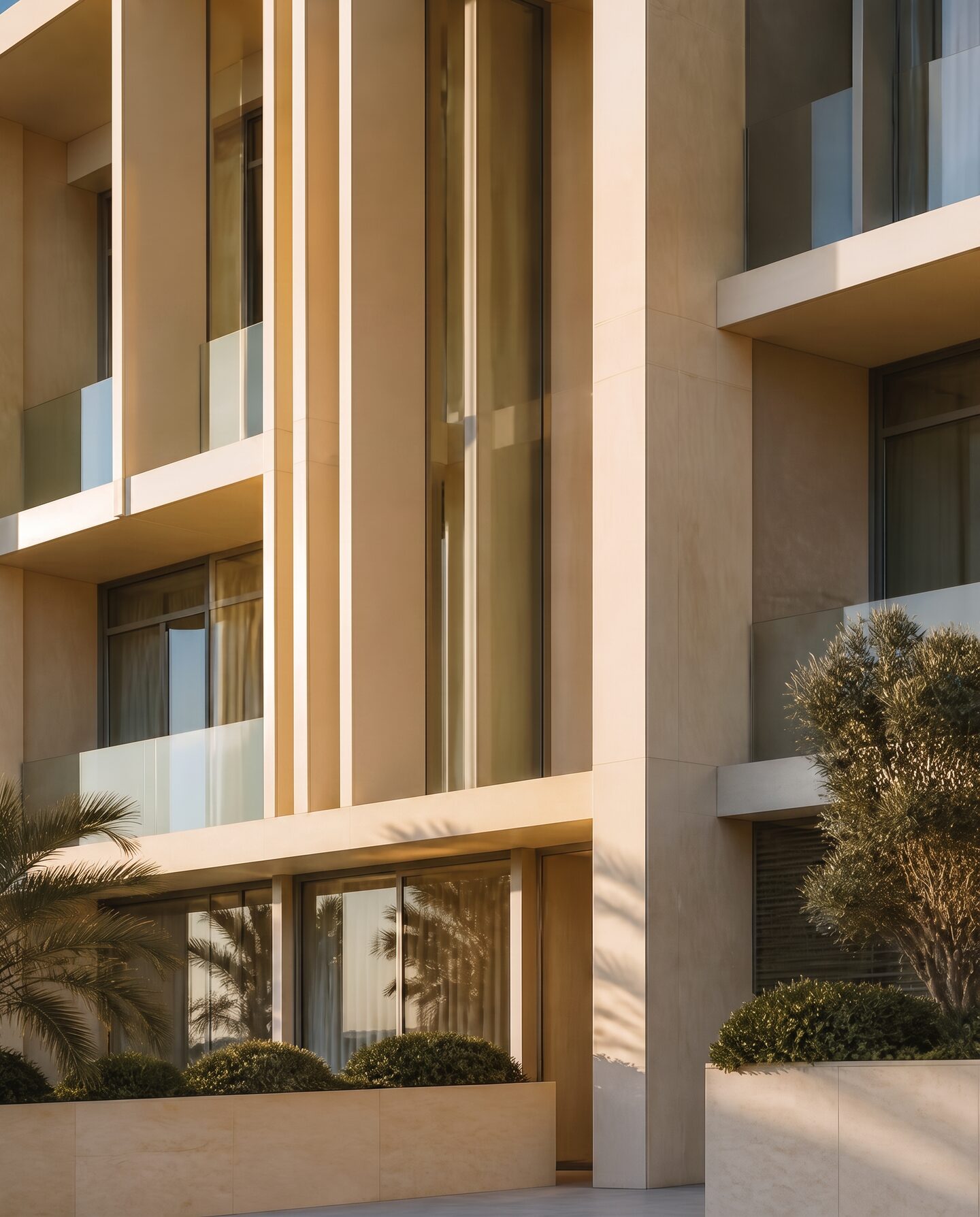 Contemporary Dubai residence with warm limestone facade and deep glass reveals